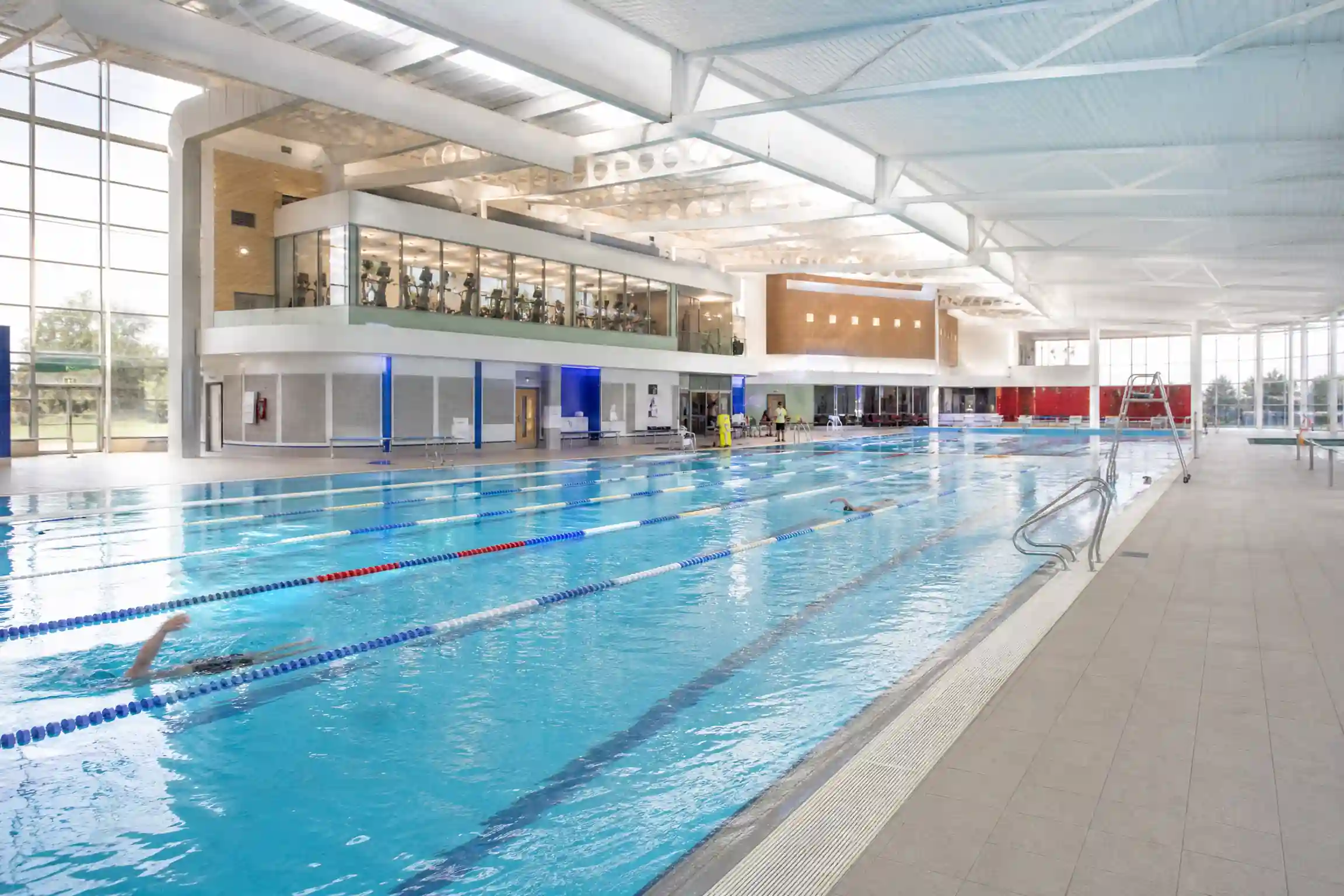 UK leisure centre indoor swimming pool with emergency lighting and fire safety systems