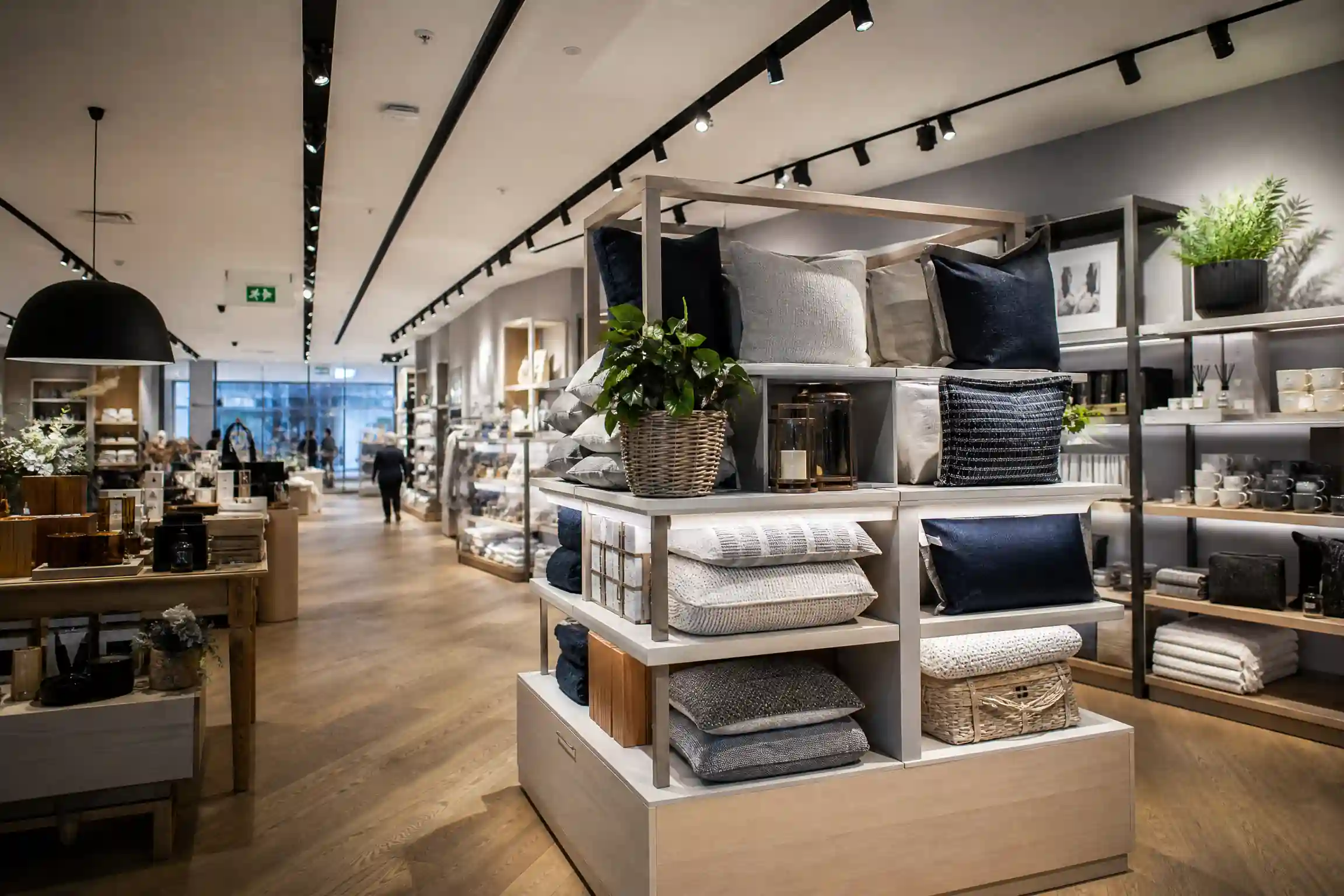 Modern UK retail store interior with product displays and fire safety signage